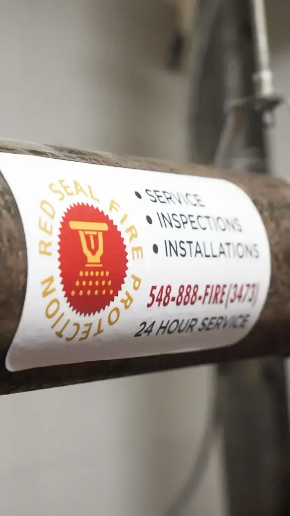 Red Seal service vehicle decal with 548-888-FIRE and 24-hour service.