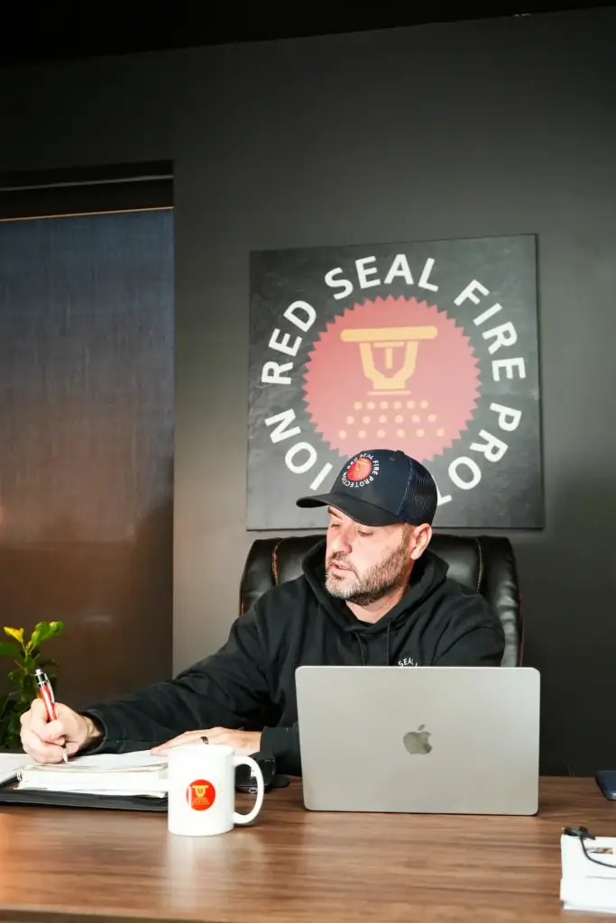 Red Seal team member at a desk in the Red Seal office.